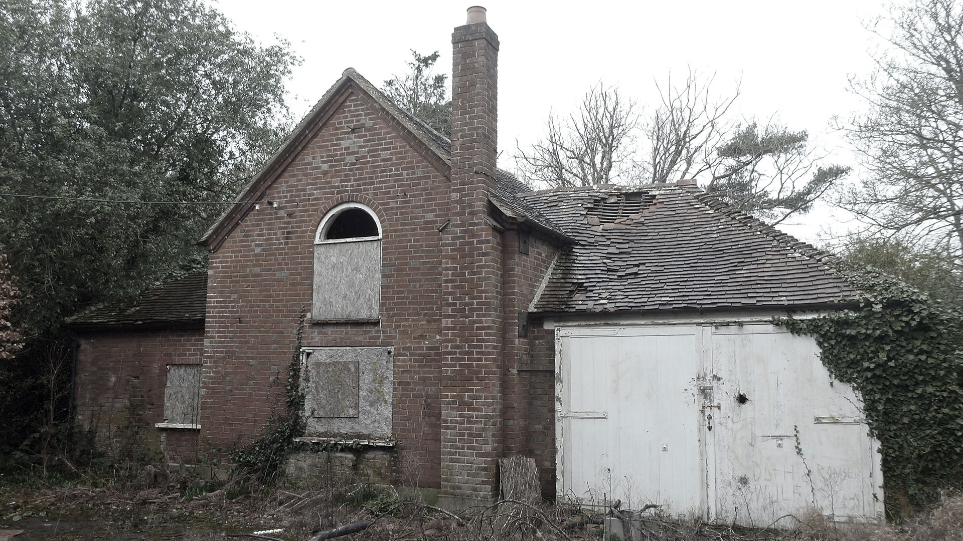 before photo of red brick house in need of repair