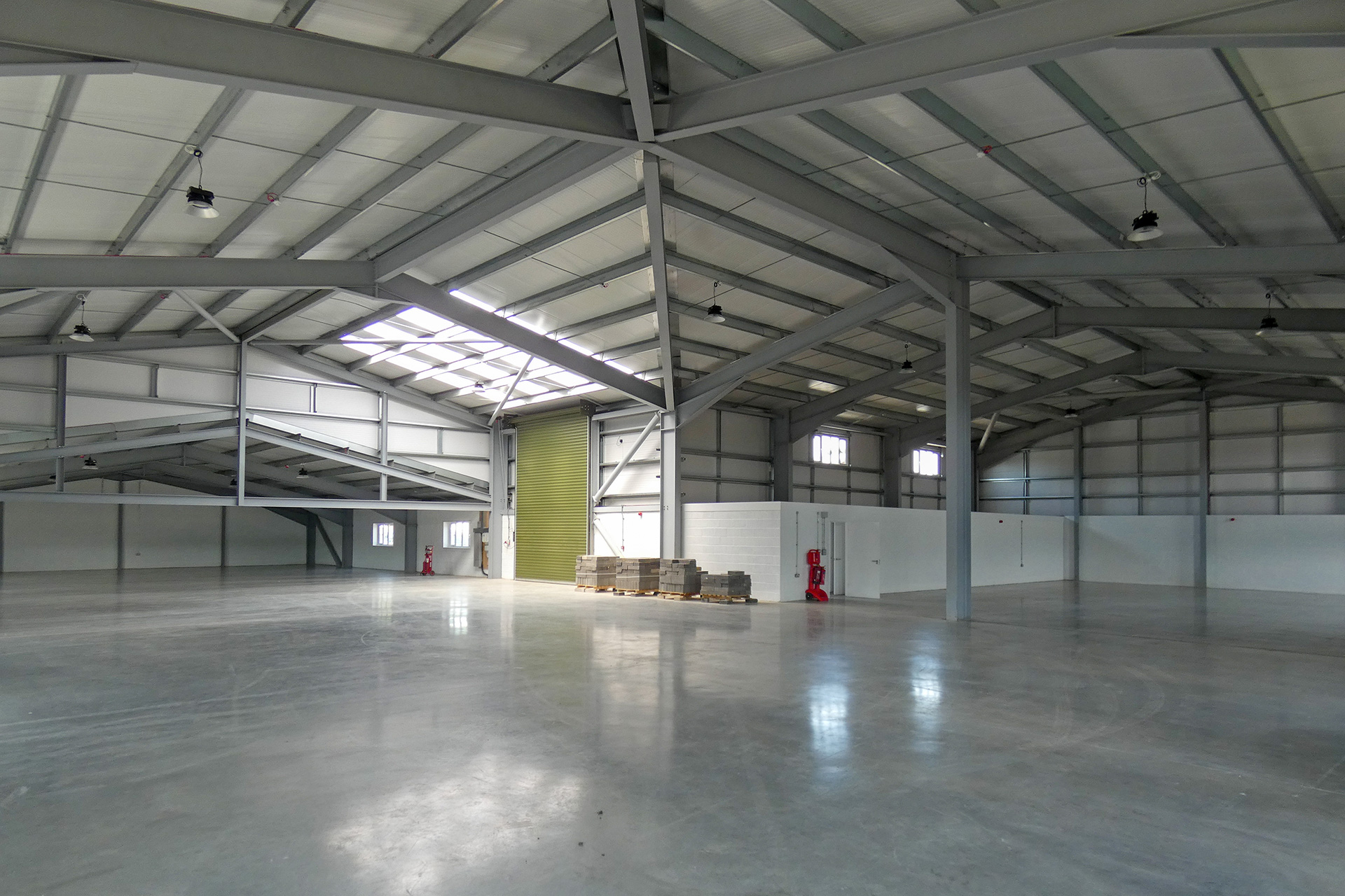 interior of large industrial L- shape unit with roof lights