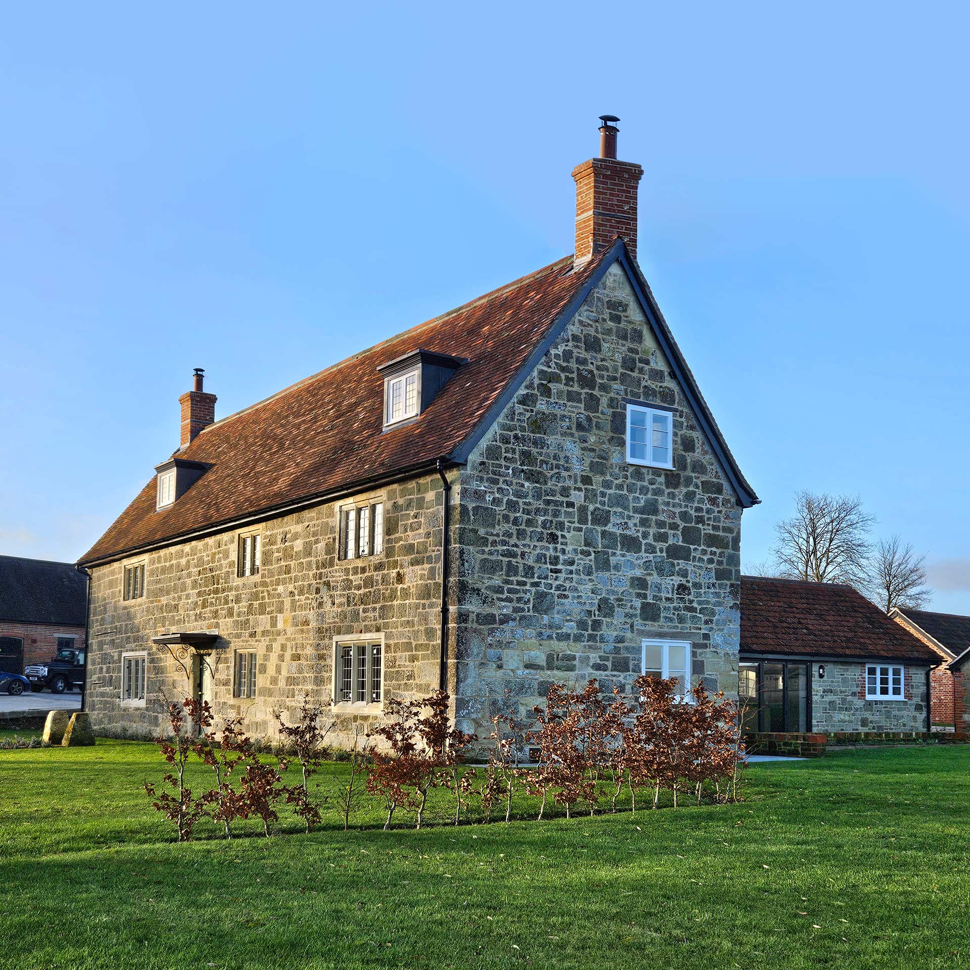 traditional stone detached house with red tiled roof