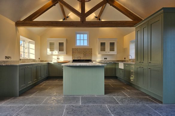 contemporary kitchen in green with vaulted ceiling and exposed beams