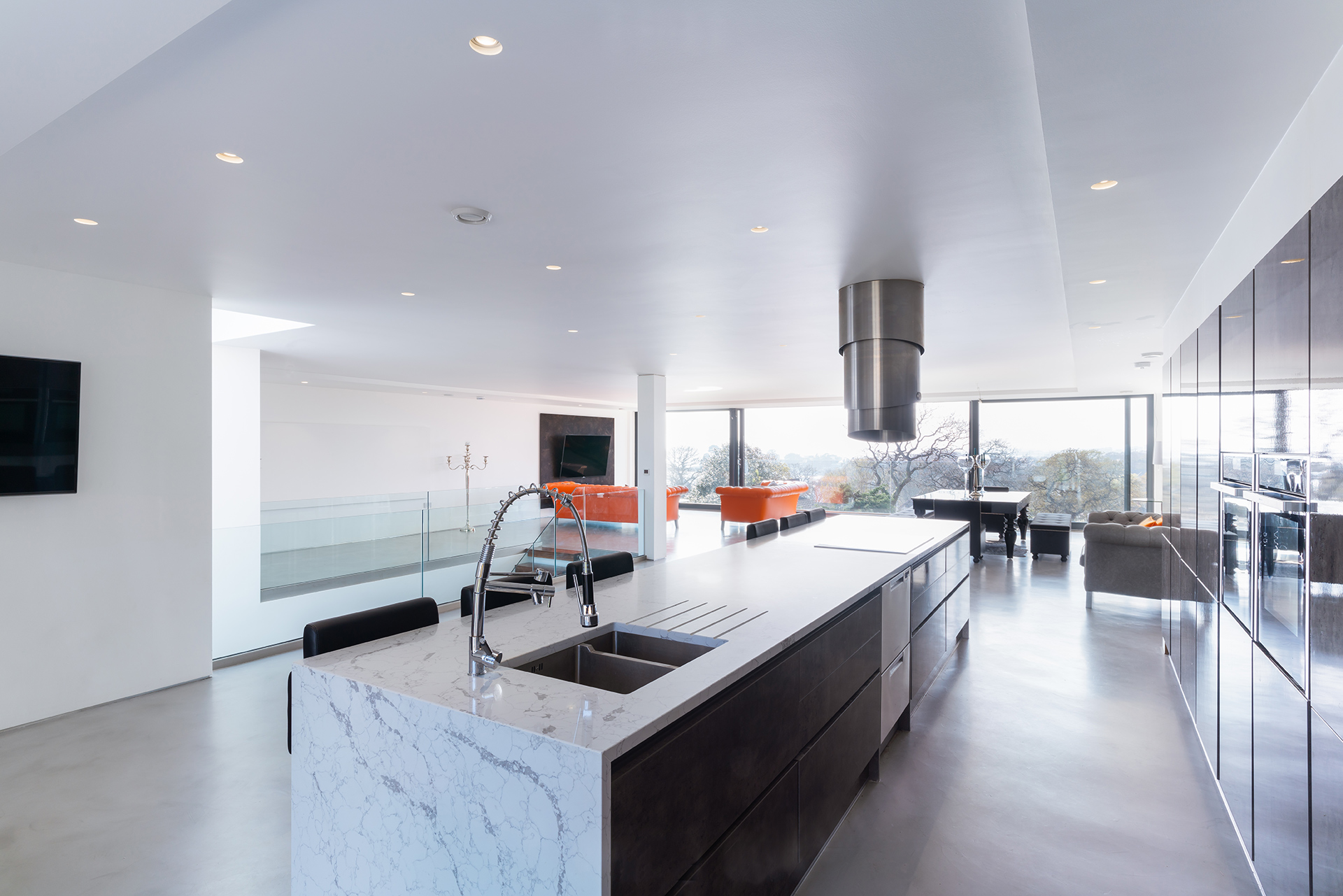 contemporary open plan kitchen in black and white theme with large kitchen island