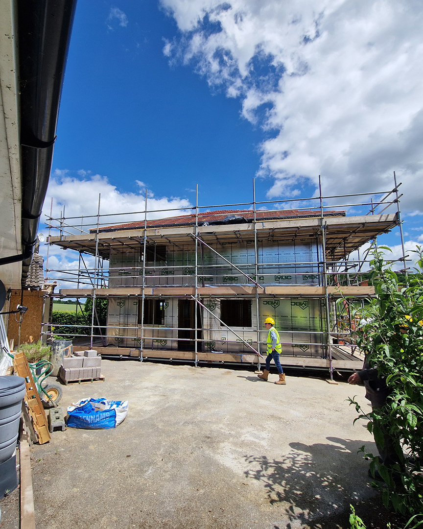 exterior front view of house under construction with scaffolding