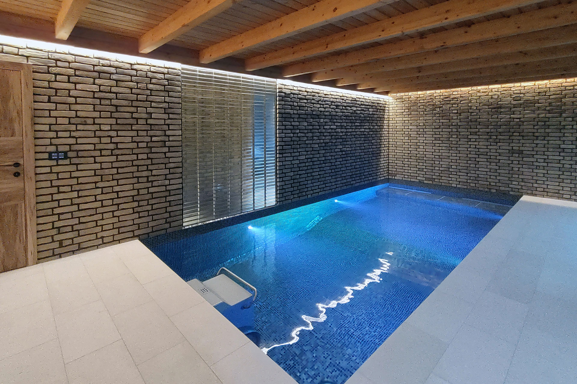 Indoor swimming pool with stone brick wall