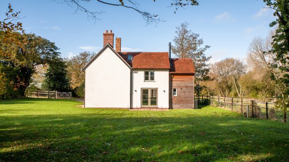 side elevation of traditional rural house with timber cladding extension