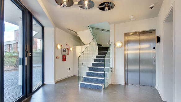 Modern communal entrance to apartments with stairs and lift