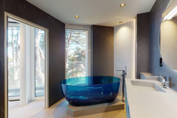 contemporary bathroom with blue glass freestanding bath