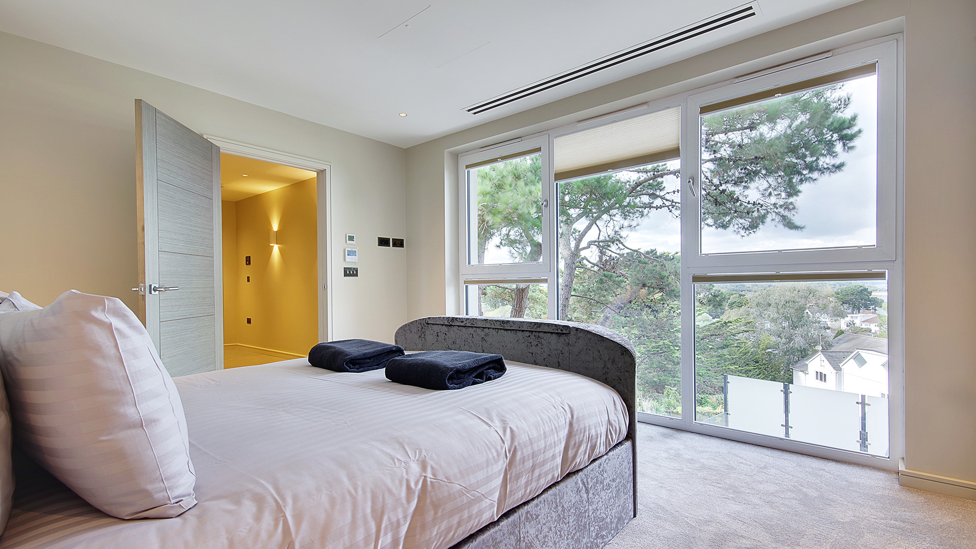 modern bedroom with large windows and sea views