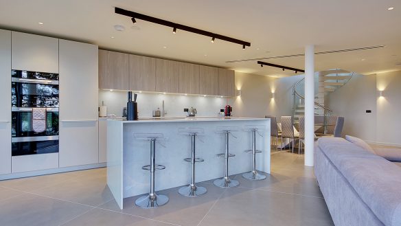 contemporary open plan kitchen with island and spiral staircase