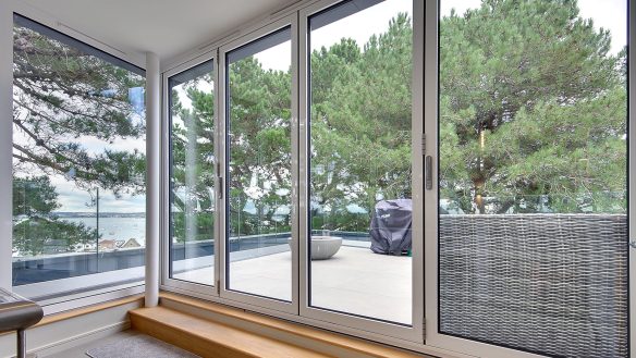 pent house and balcony with glass balustrade and sea views