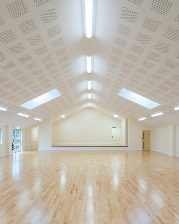 village hall internal space with wood floor and vaulted ceilings