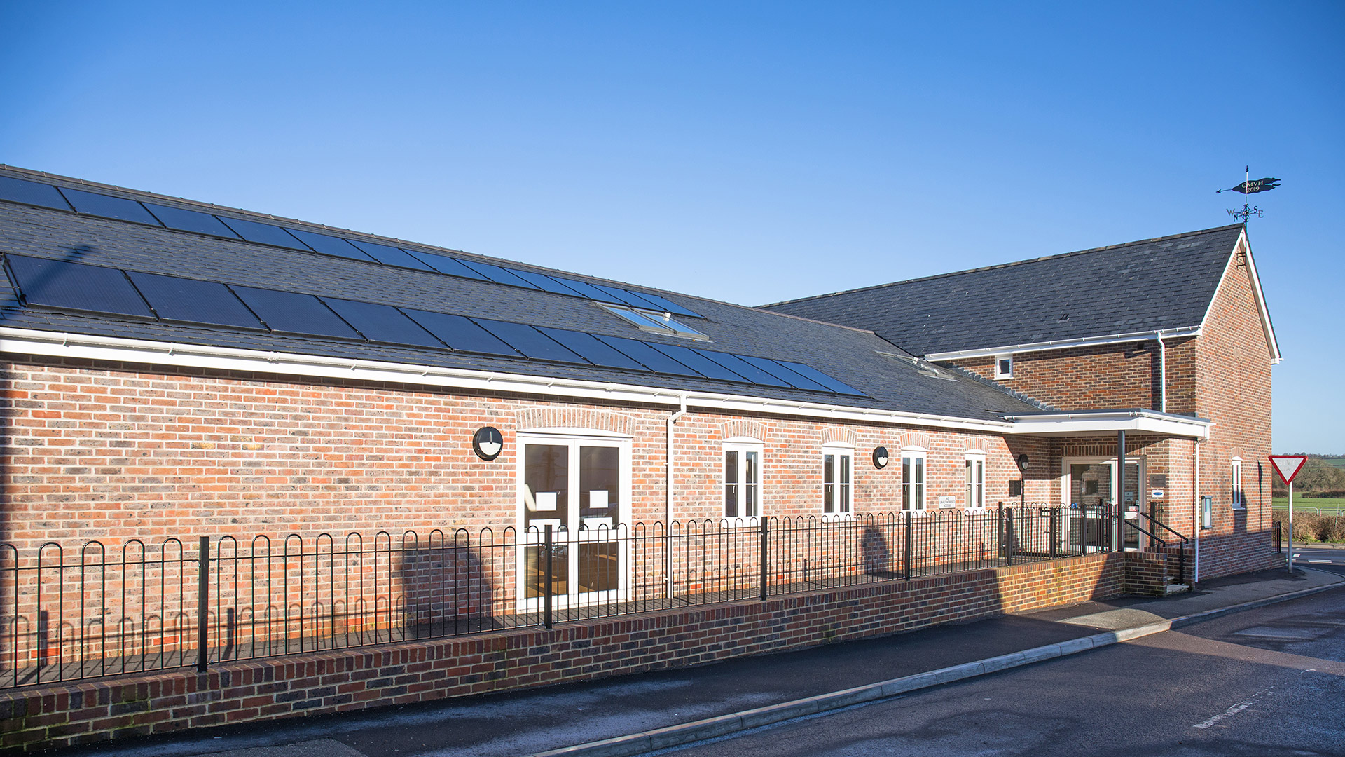 red brick village hall with two storeys