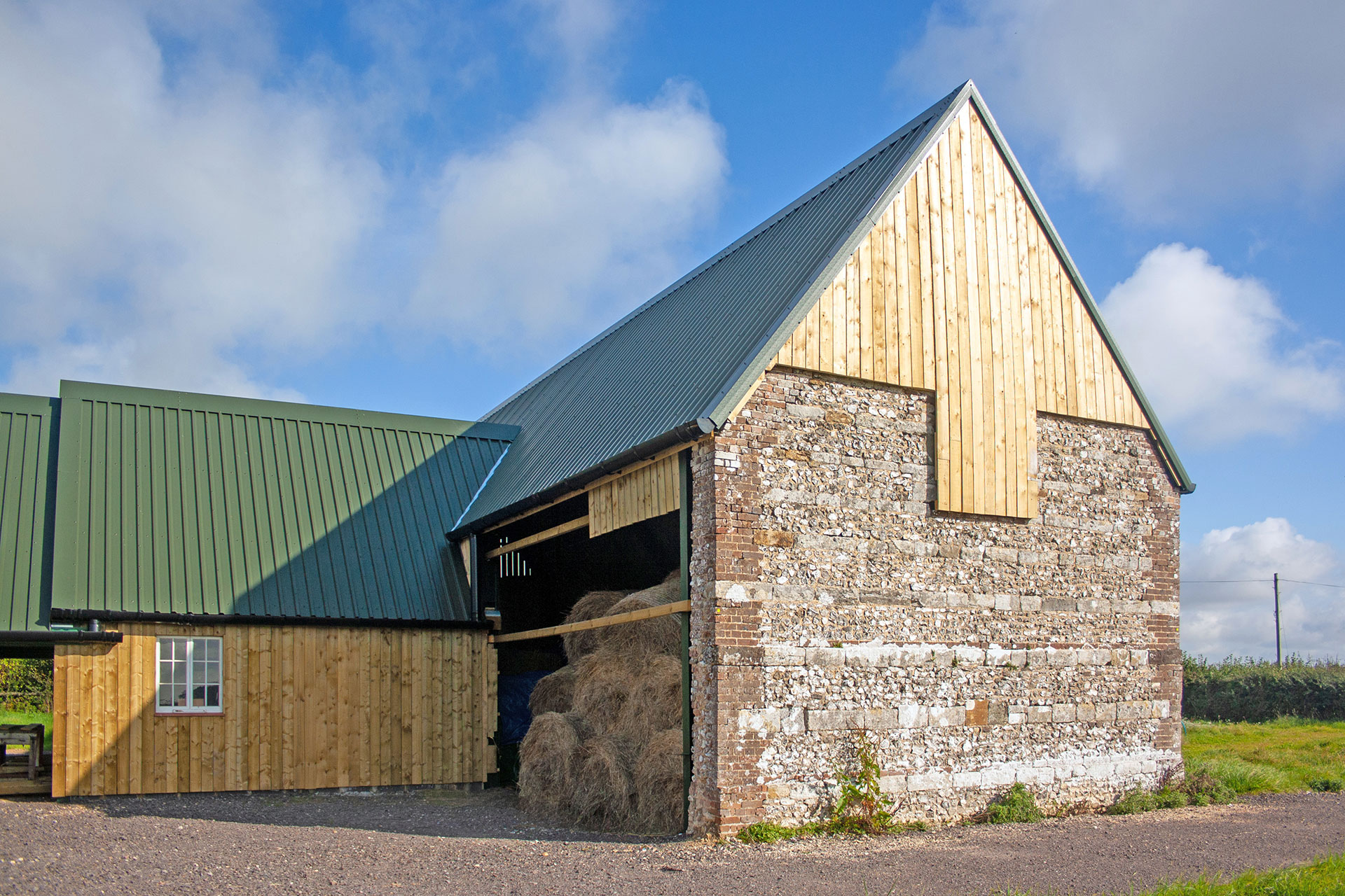 steal frame barn with timber cladding and original stone wall