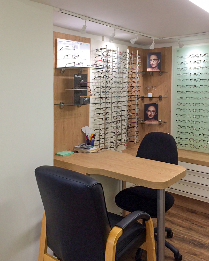 opticians shop display area with table and chairs