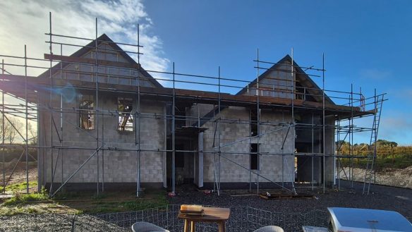 New home under construction with scaffolding, gable end