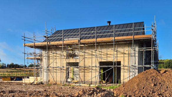 Side view of new house under construction with scaffolding