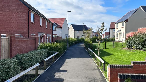 pathway through housing development with street lamps on path