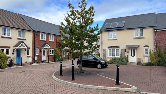 street scene in housing development with red brick road