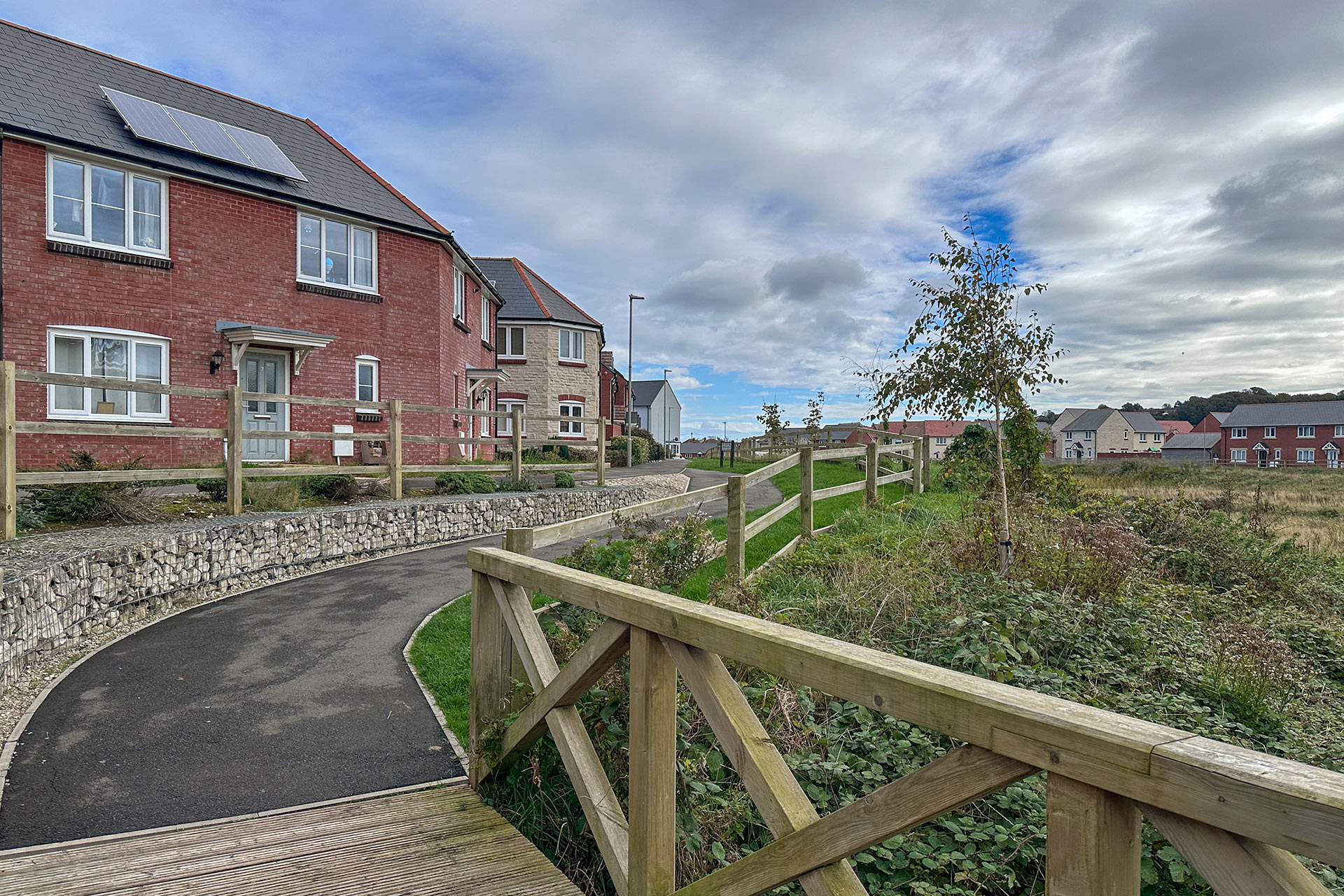 boundary path around housing development with wooden railing