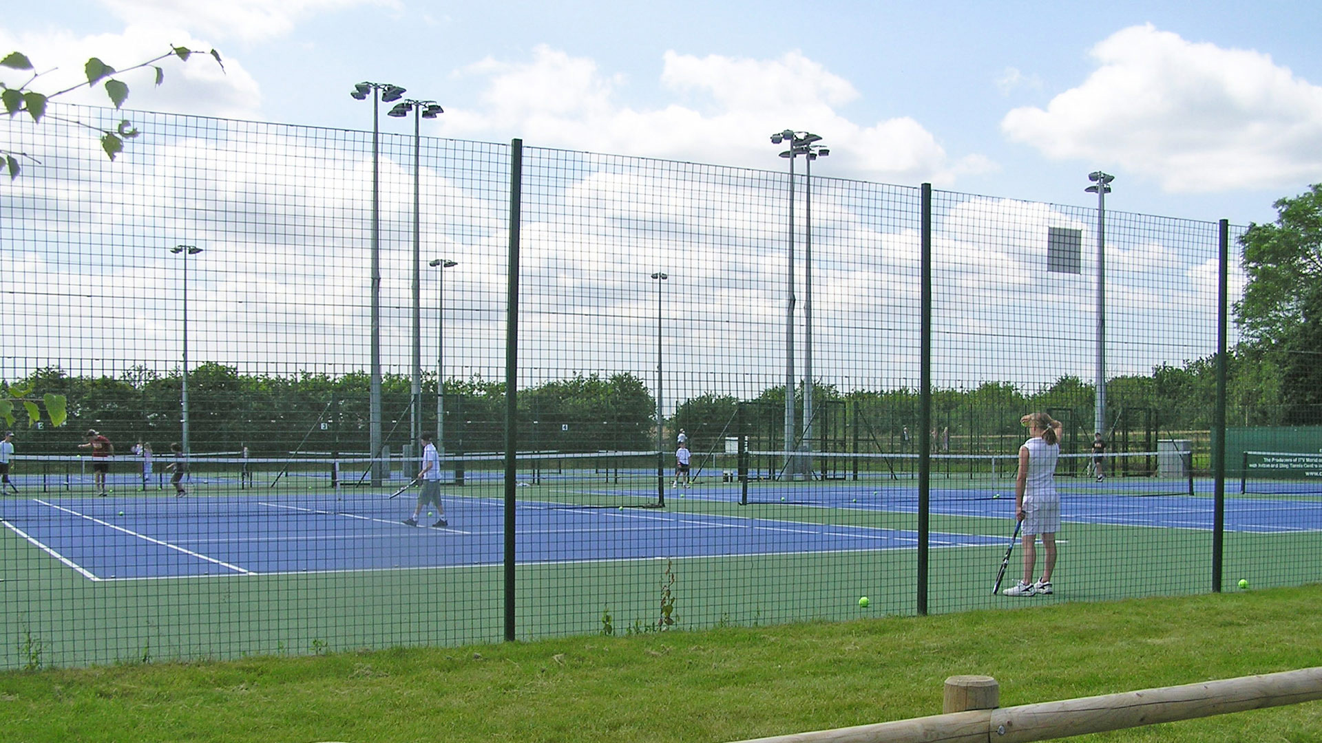 tennis courts taken from behind fence