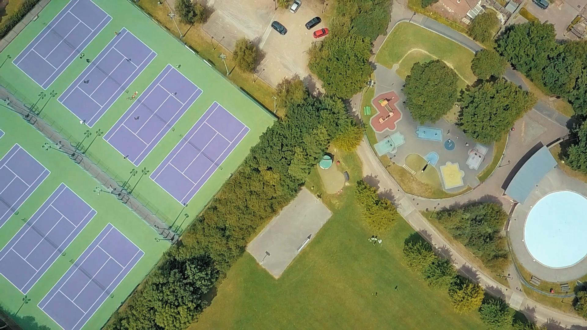 aerial view of tennis courts and play park